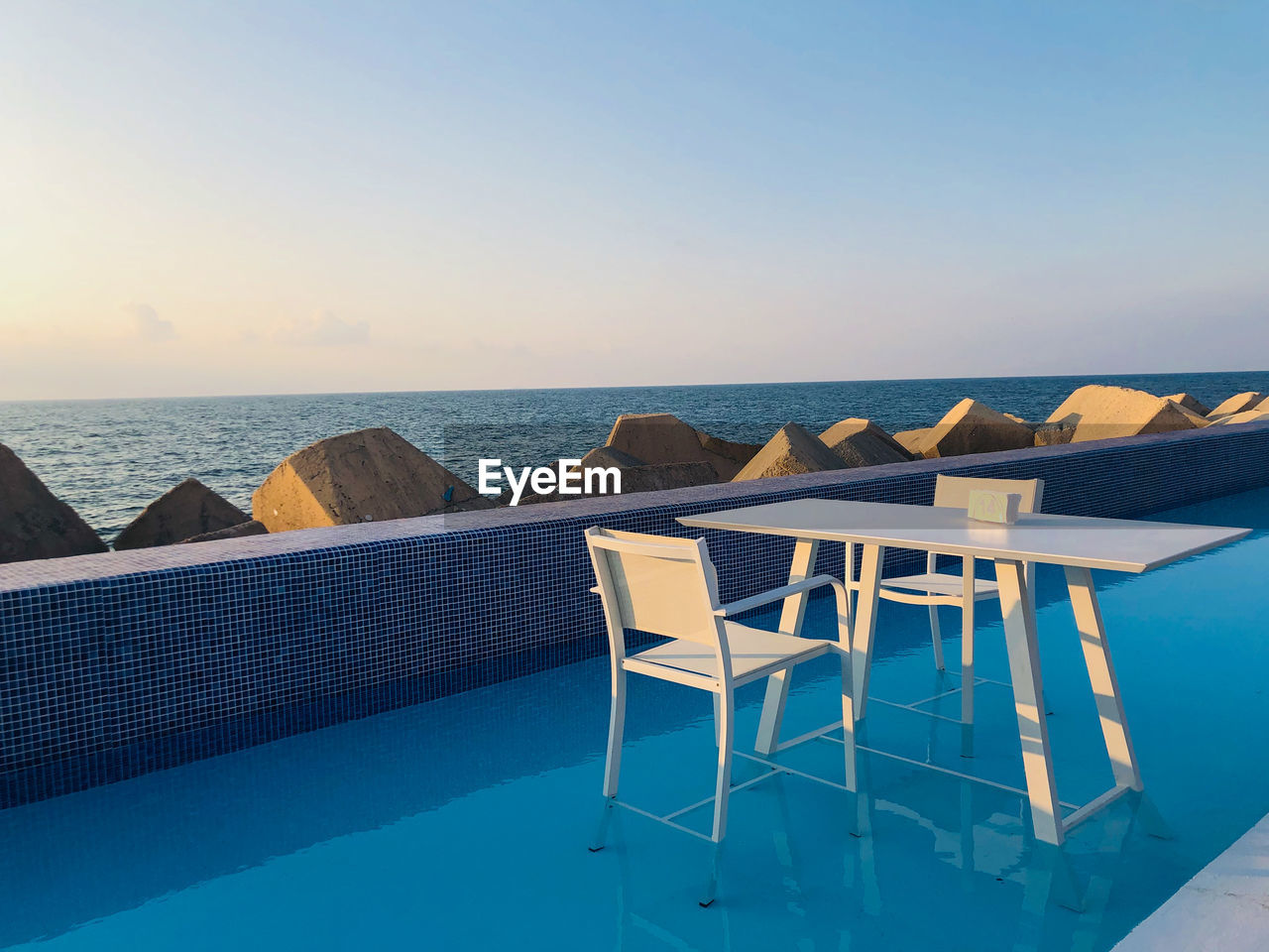 View of swimming pool at beach against clear sky