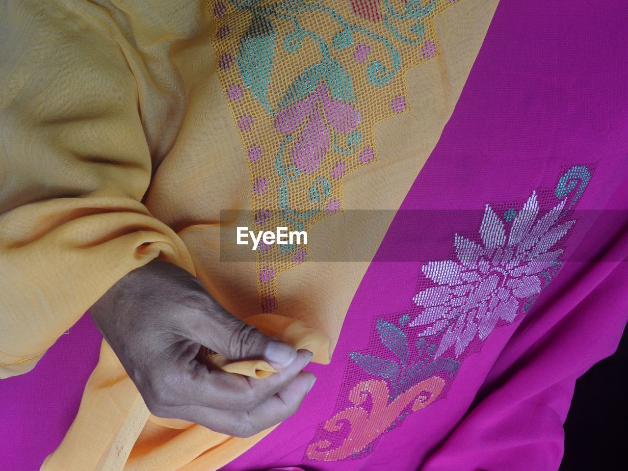 Midsection of woman wearing karawo cloth, a traditional cloth of gorontalo, indonesia.