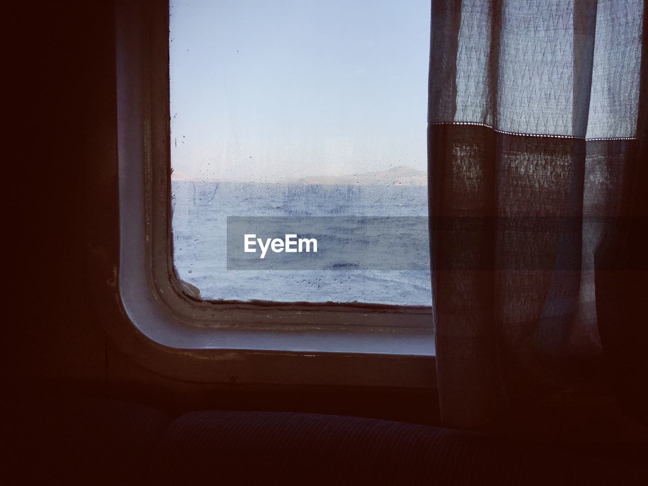 View of sea seen through window