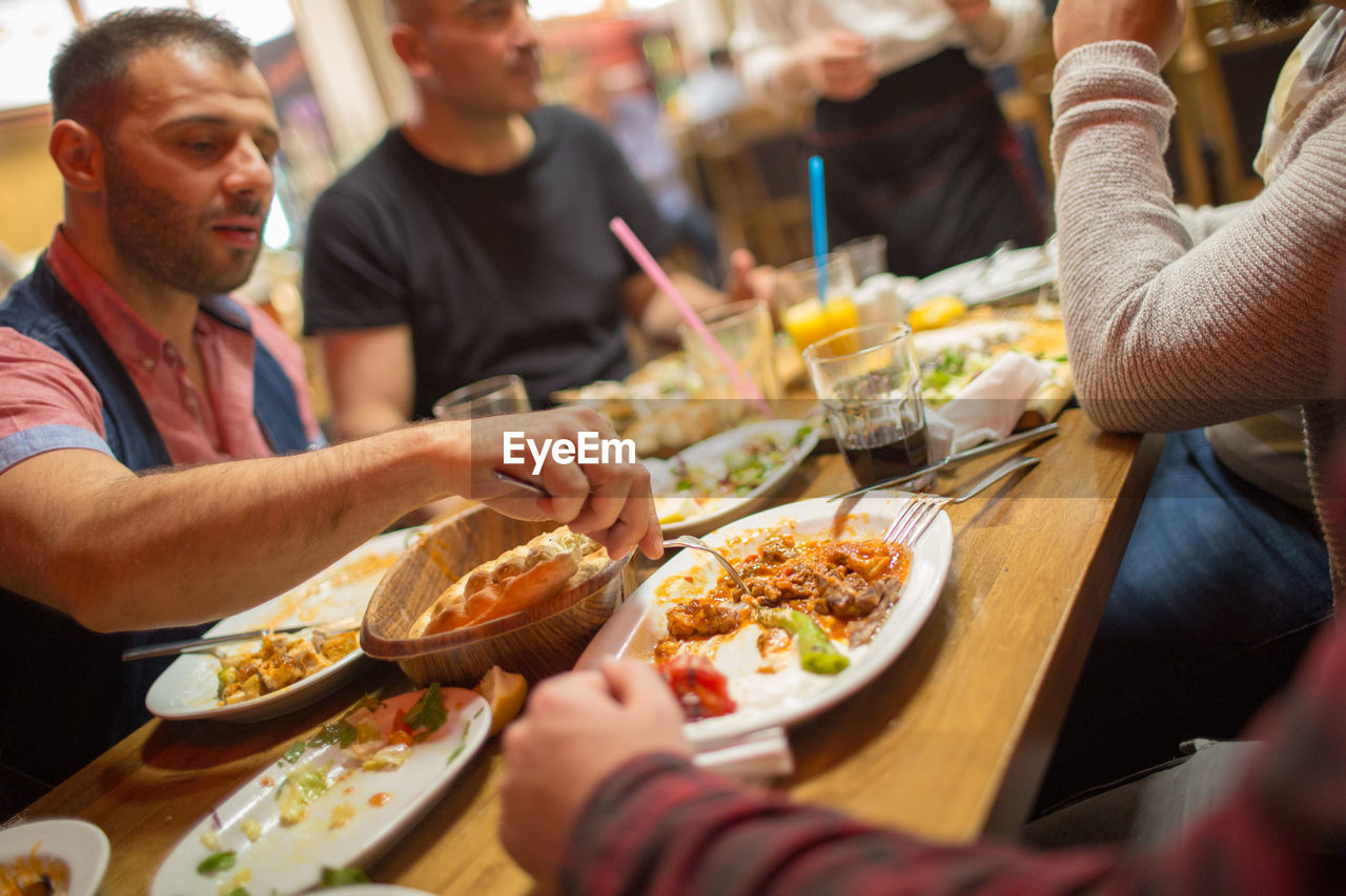 Group of people having meal in restaurant