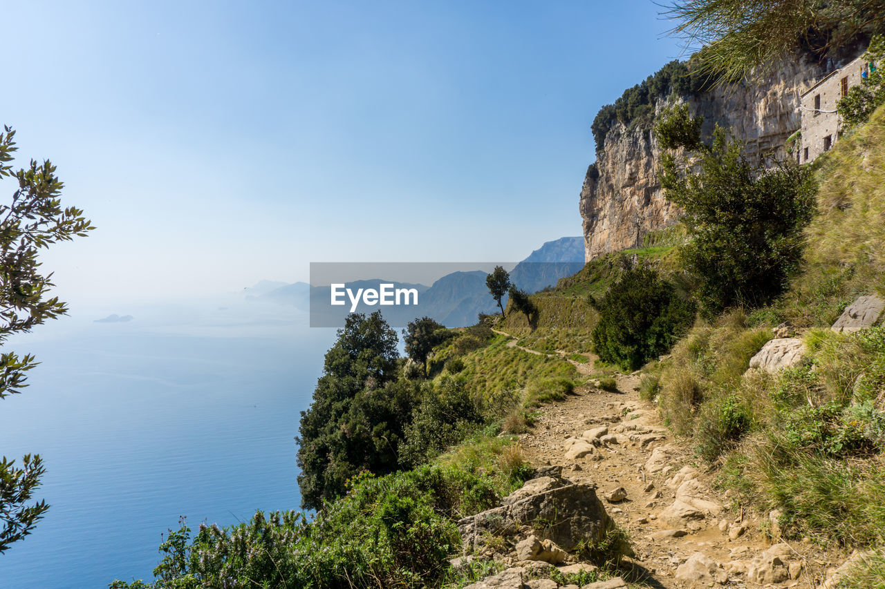 Scenic view of mountains against blue sky