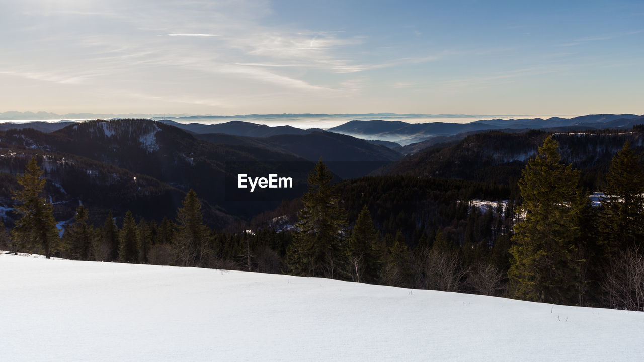 Scenic view of snowcapped mountains against sky during winter