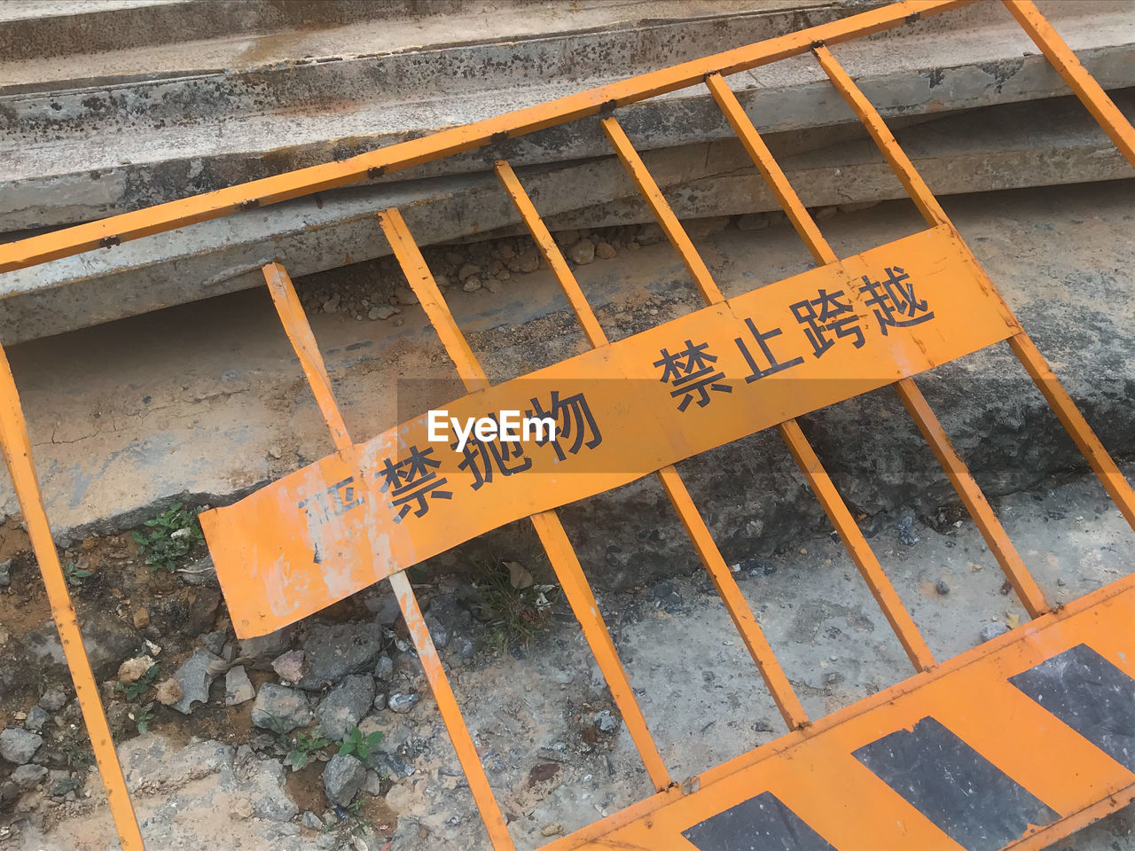 text, communication, wood, sign, high angle view, western script, no people, wall, track, architecture, floor, yellow, day, outdoors