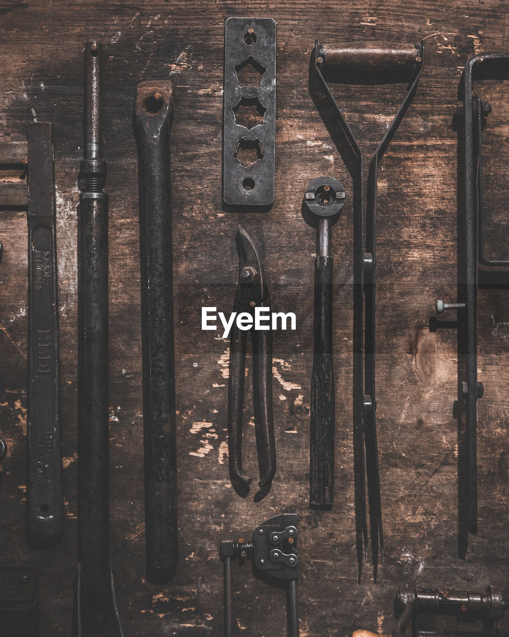 View of work tools hanging on wooden wall