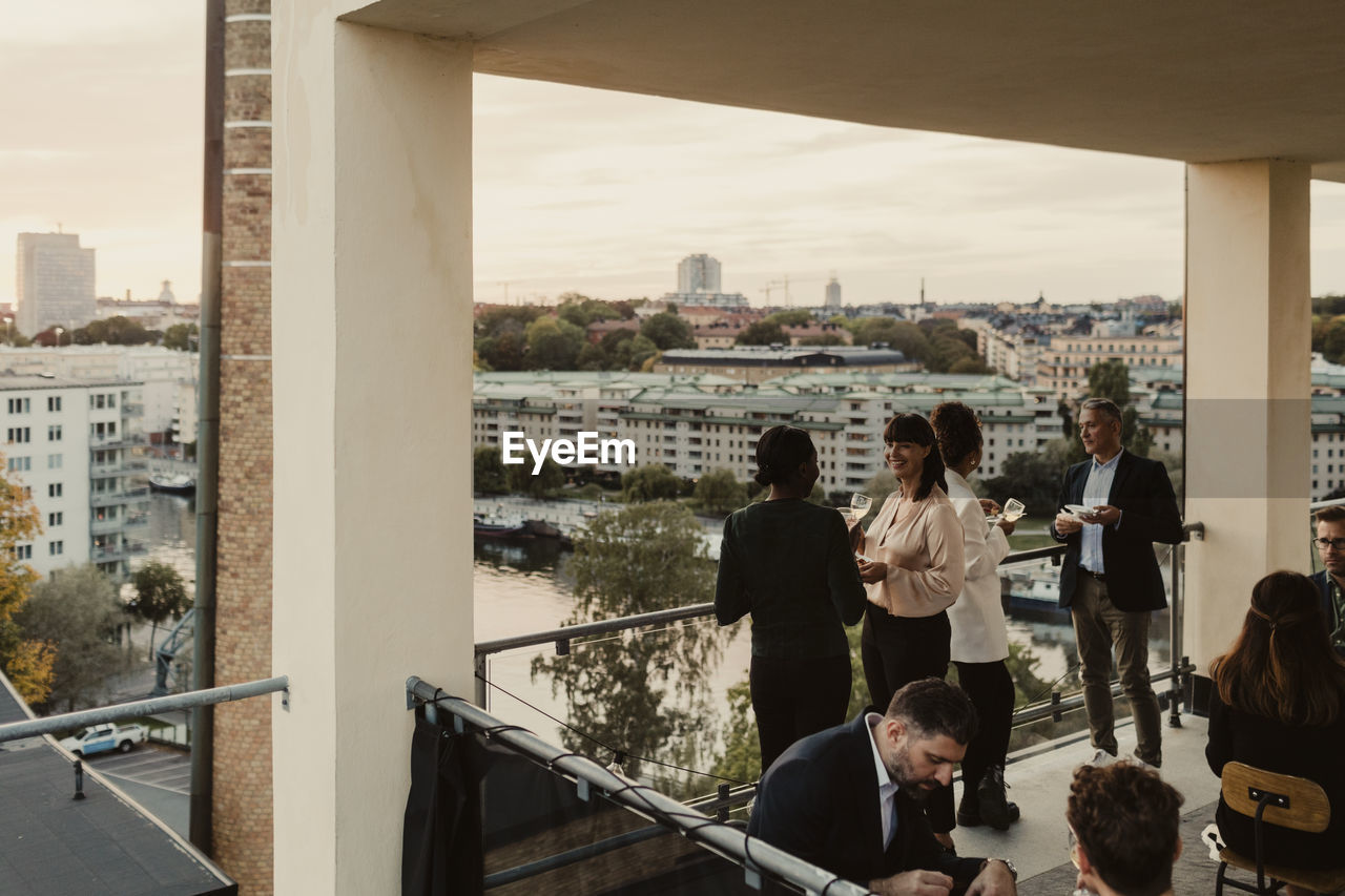 Smiling business people discussing during office party