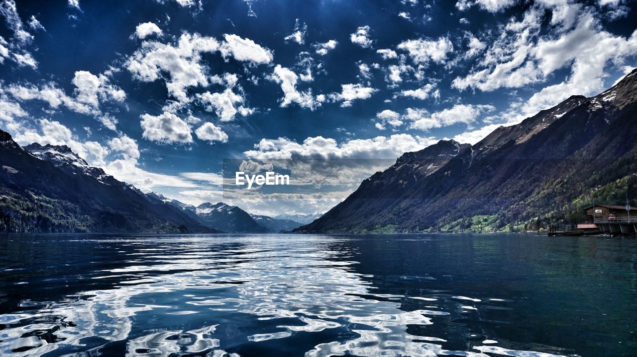 Scenic view of calm lake against mountain range