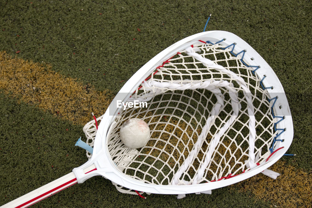 HIGH ANGLE VIEW OF BALL ON FIELD BY ROAD