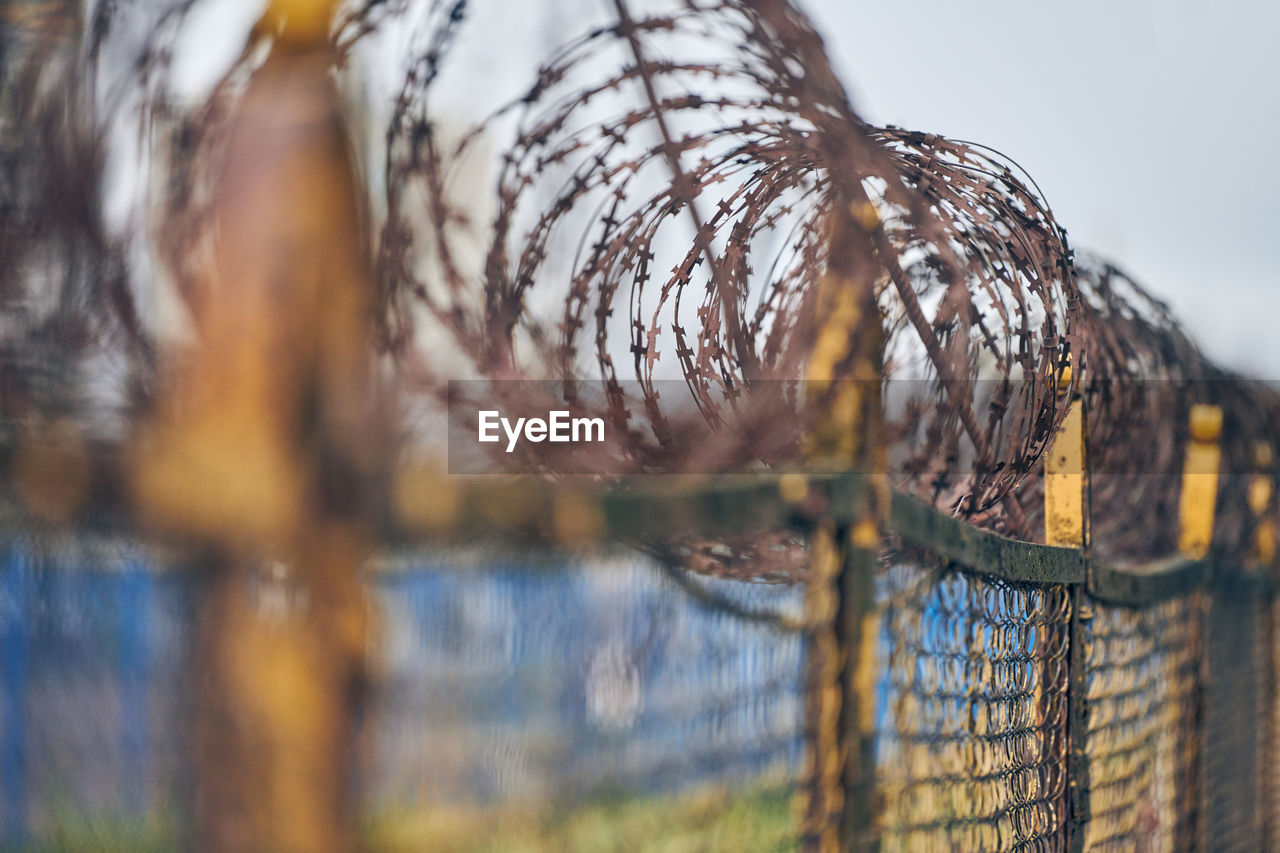 Barbed wire on fence of restricted area. no unauthorized entry. old fence, military border territory