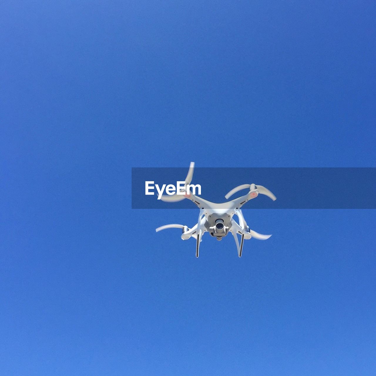 Low angle view of drone flying in sky