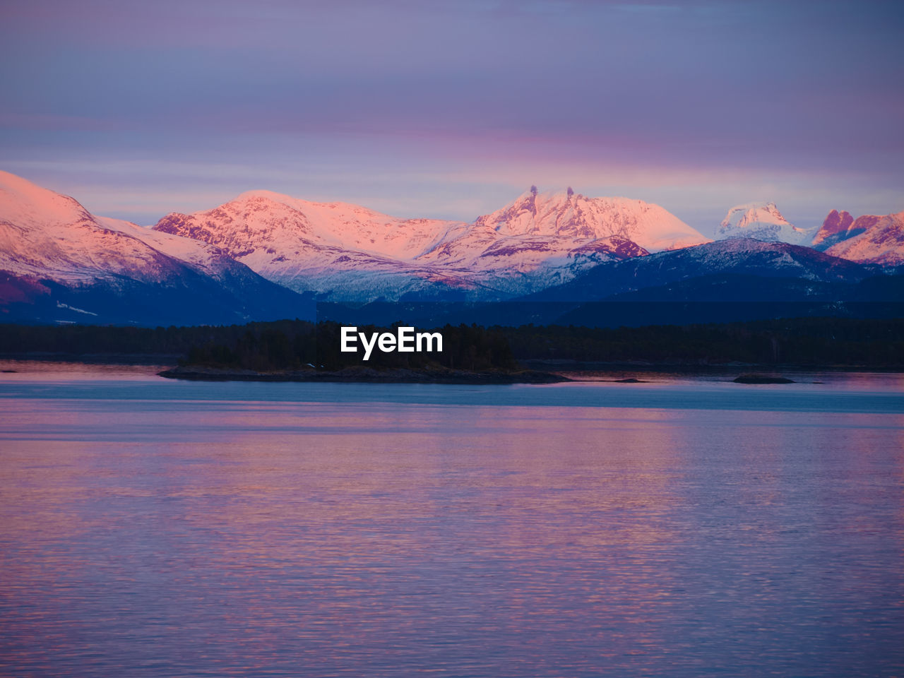 Scenic view of lake against sky at dusk