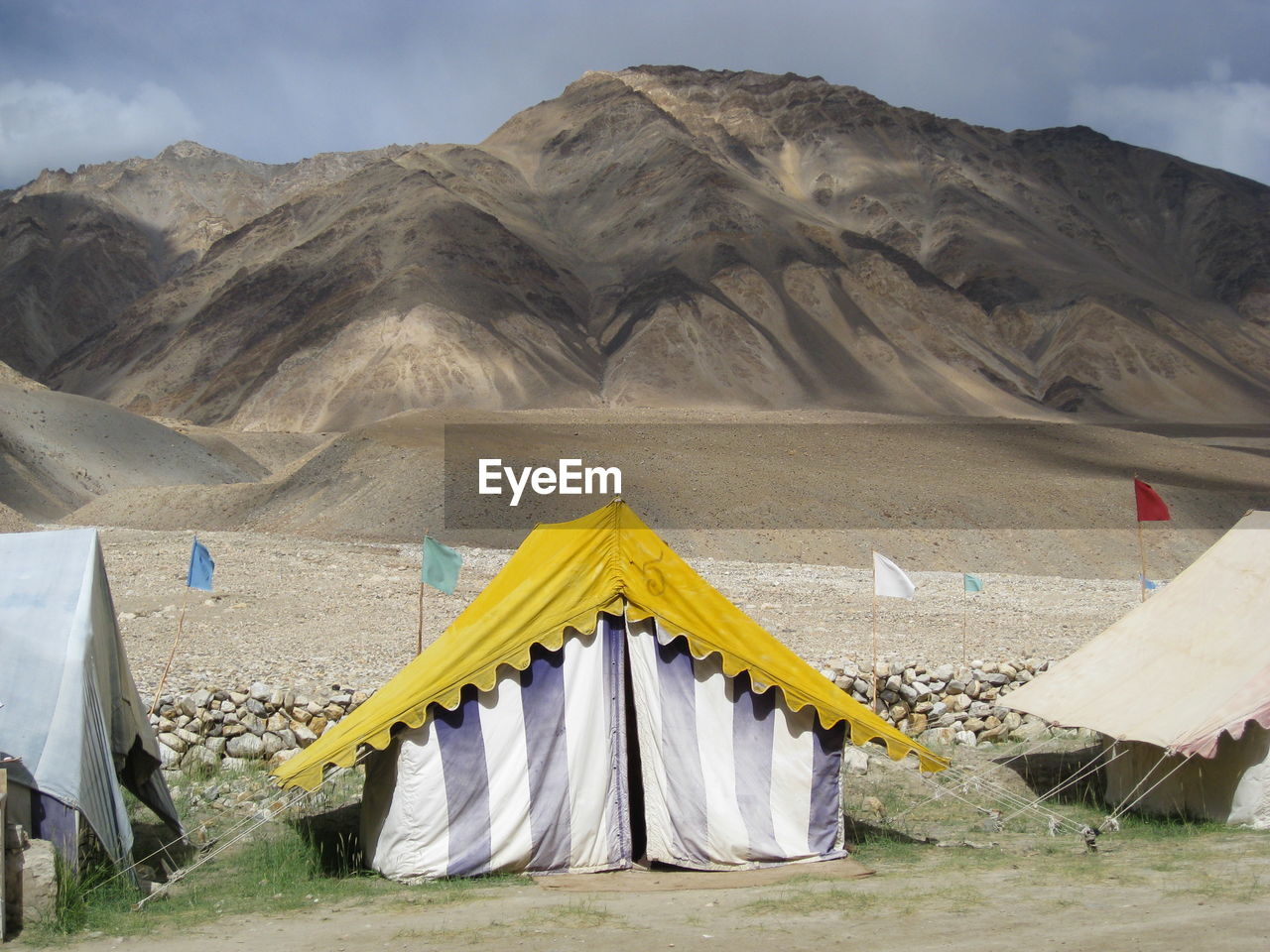 Tents at desert against sky