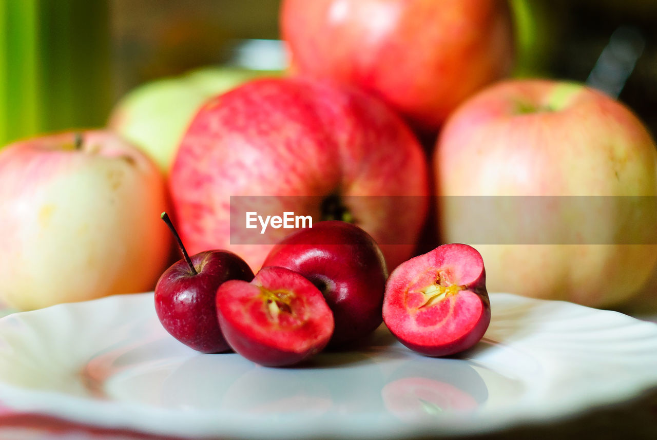 Close-up of small apples in plate