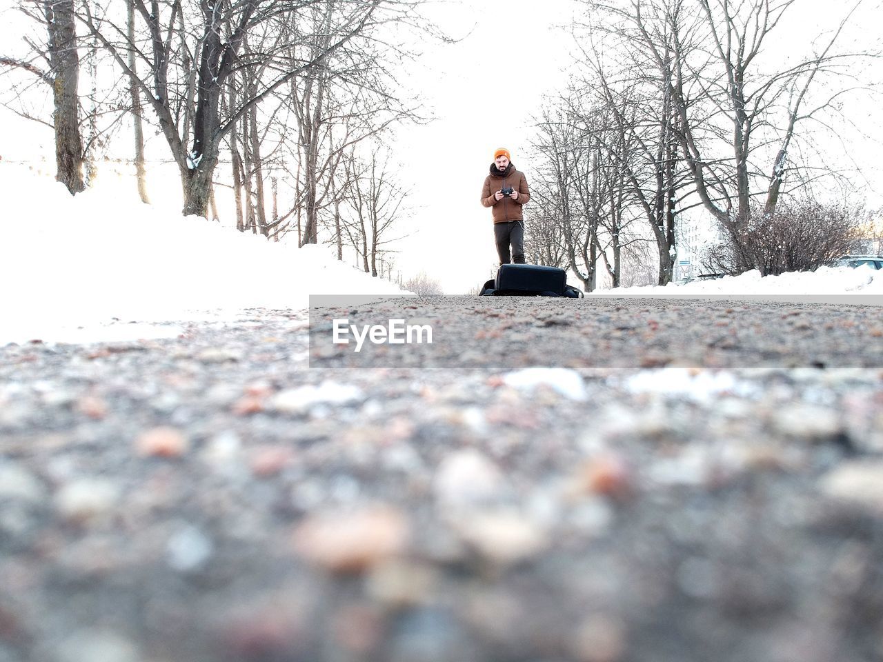 MAN STANDING IN SNOW