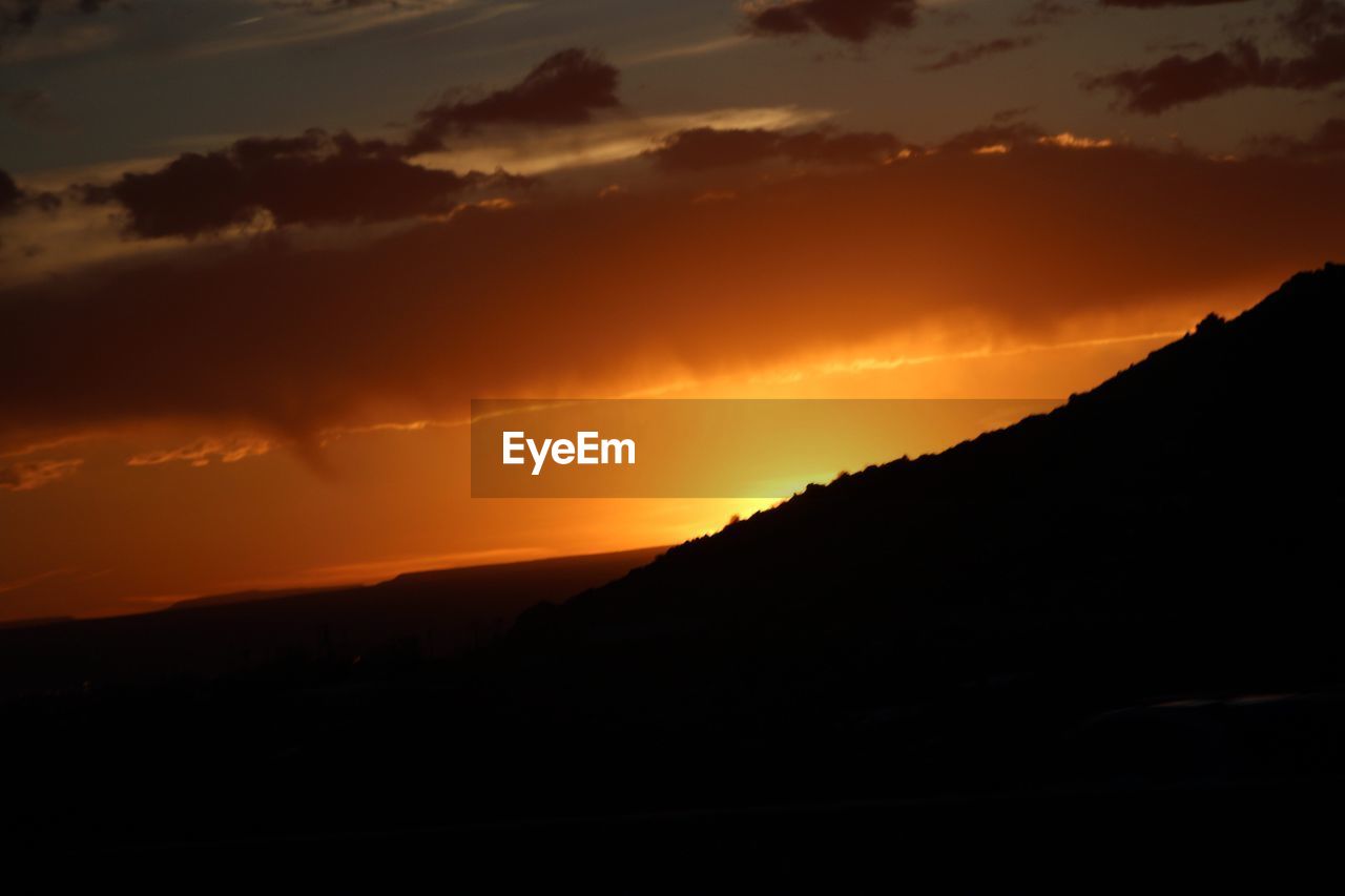SILHOUETTE LANDSCAPE AGAINST SKY DURING SUNSET