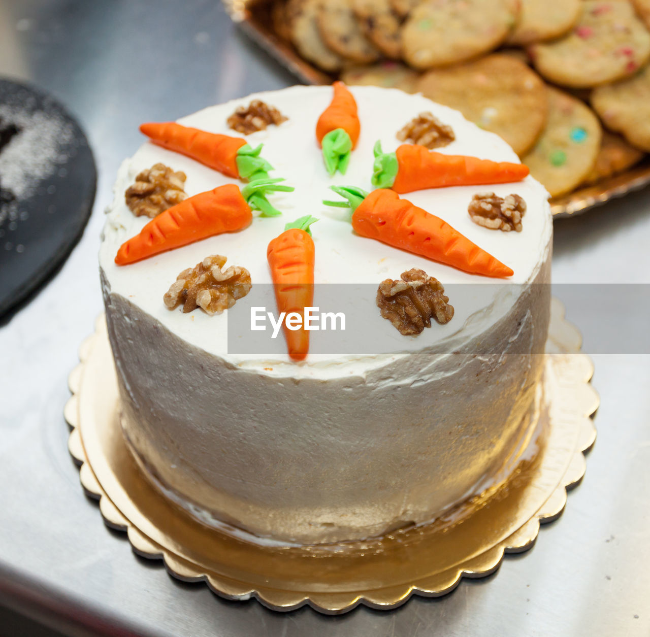 Carrot cake with cream cheese frosting and little carrots on top