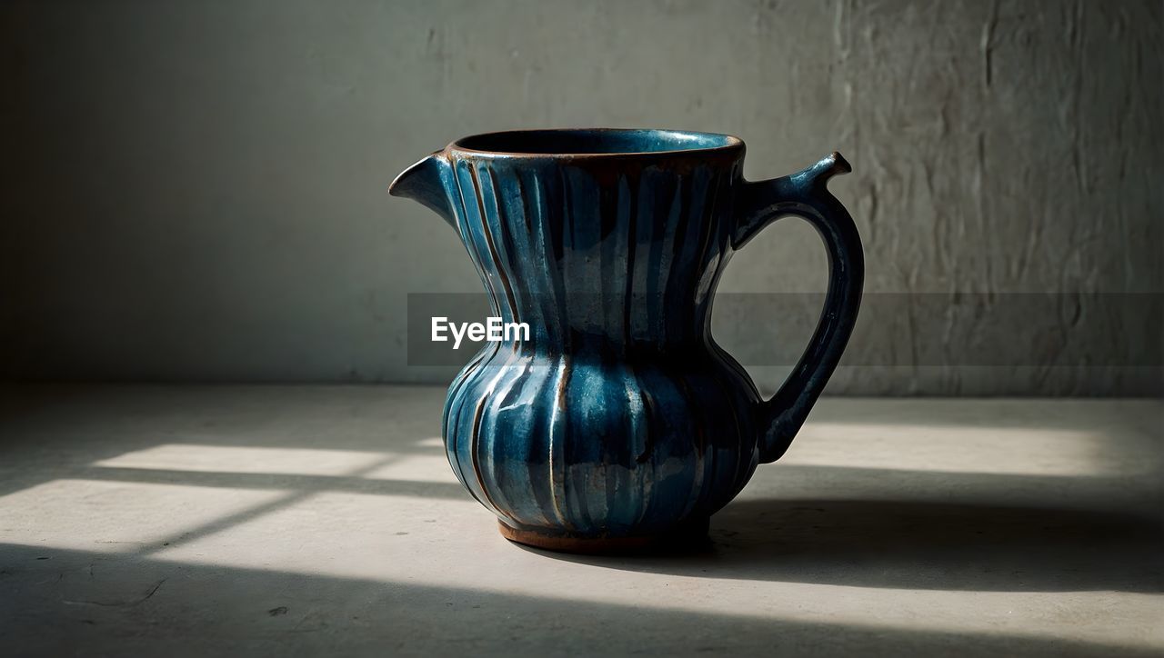 close-up of coffee on table against wall