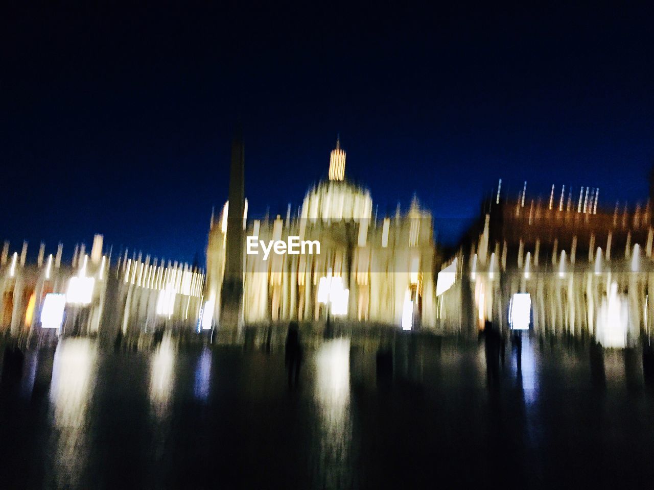 PANORAMIC VIEW OF ILLUMINATED CITY AT NIGHT