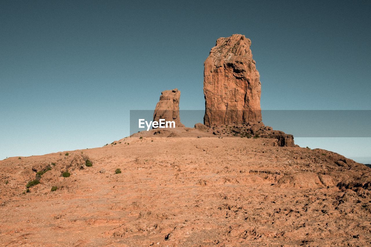 Low angle view of rock formation on land against sky