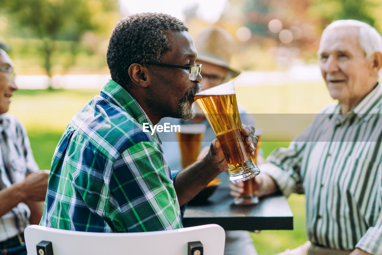 Close-up of man holding beer glass