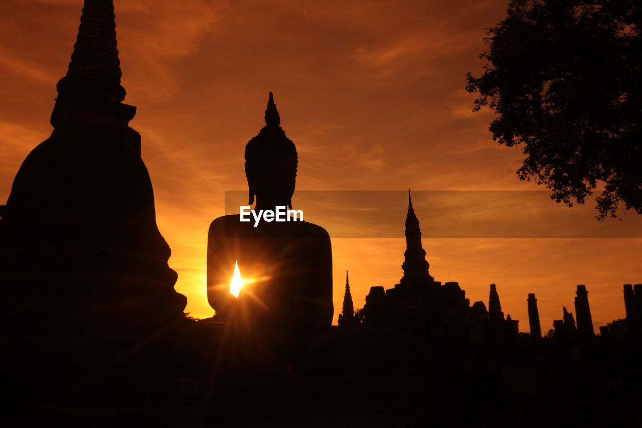SILHOUETTE OF TEMPLE AT SUNSET