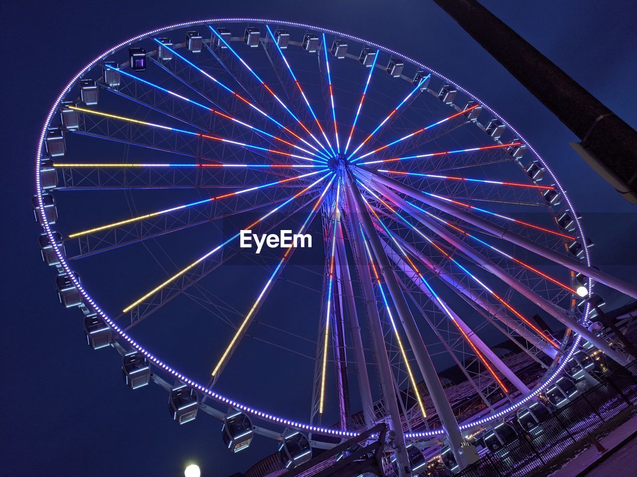 LOW ANGLE VIEW OF FERRIS WHEEL AGAINST SKY AT NIGHT