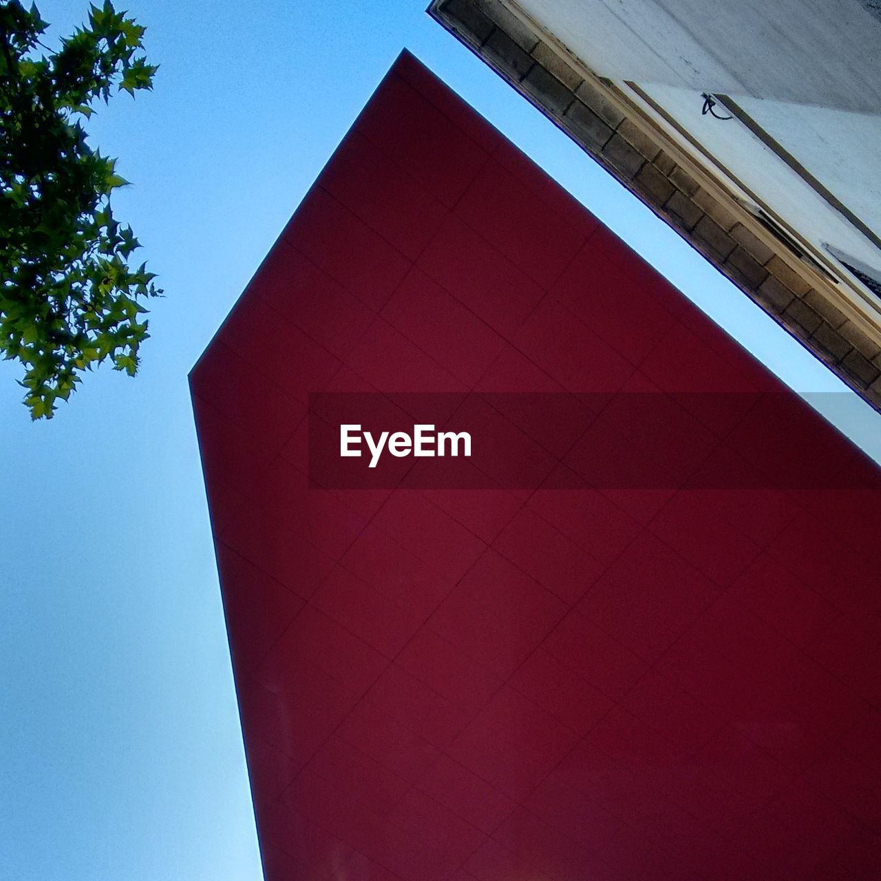 LOW ANGLE VIEW OF RED BUILDING AGAINST SKY