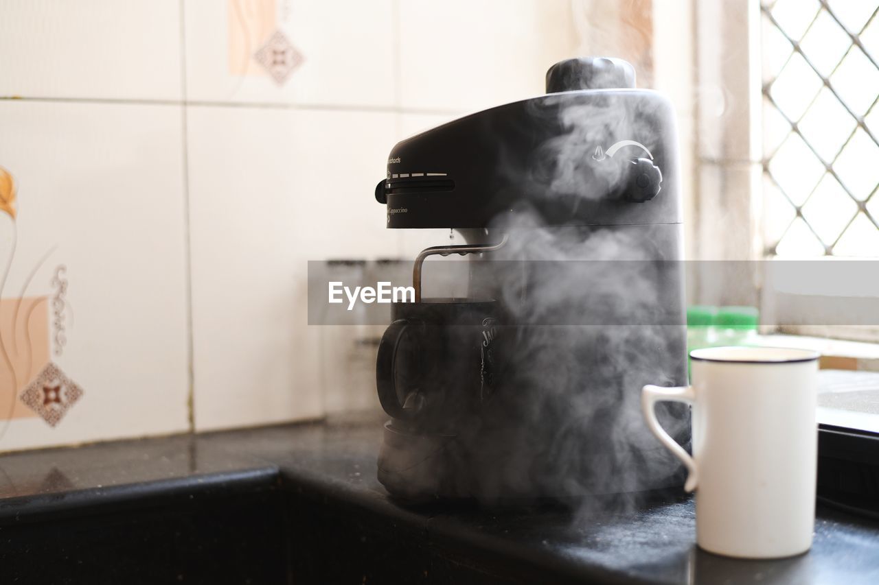 Close-up of coffee cup on table at home