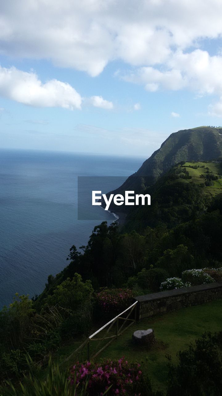 SCENIC VIEW OF SEA WITH MOUNTAIN IN BACKGROUND