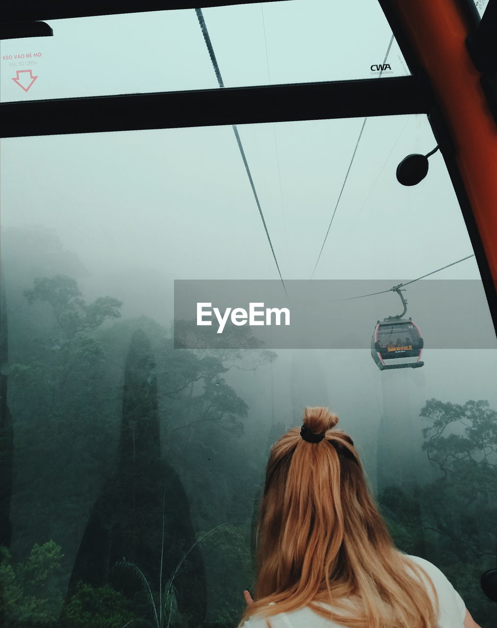 REAR VIEW OF WOMAN LOOKING AT VIEW OF MOUNTAIN