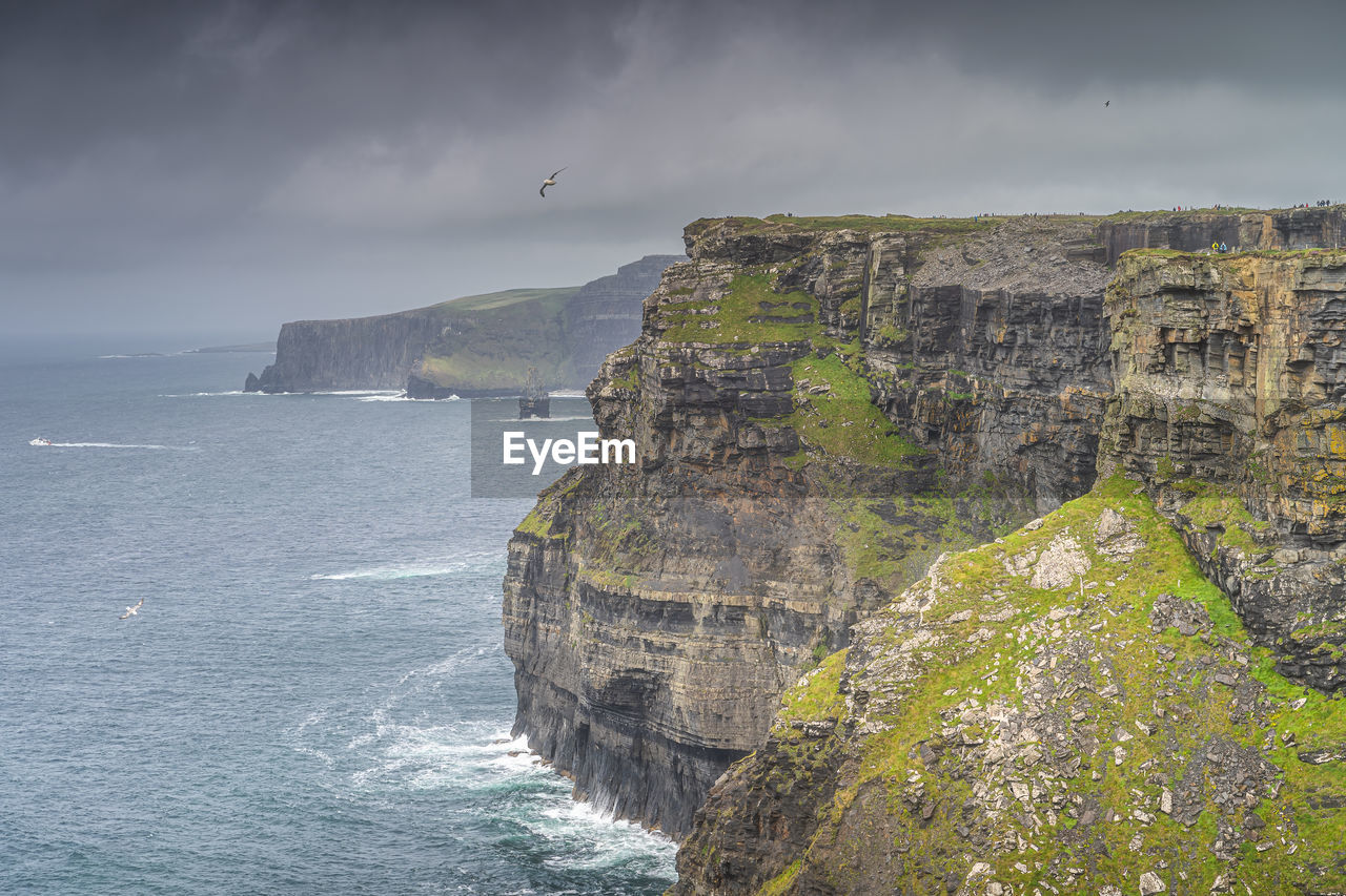 Closeup on tall, vertical walls of iconic cliffs of moher, ireland