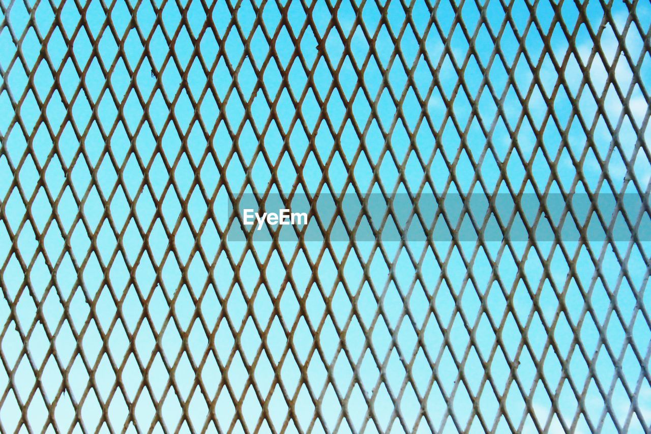 Detail shot of fence against clear blue sky