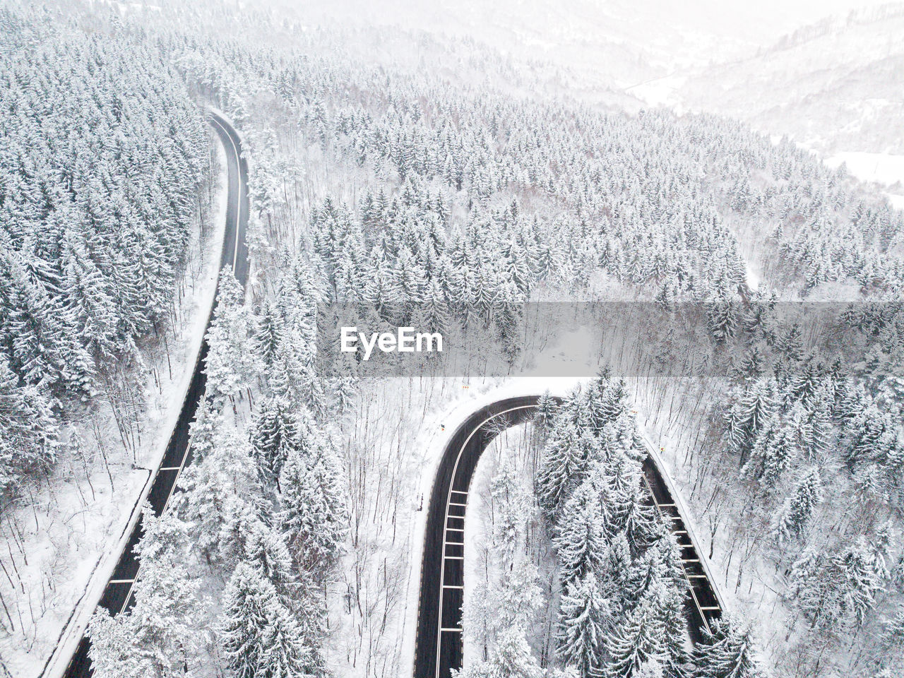 HIGH ANGLE VIEW OF SNOW ON ROAD AGAINST MOUNTAIN