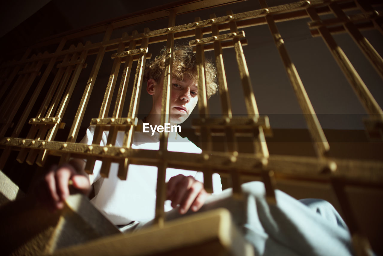 PORTRAIT OF TEENAGE BOY PLAYING PIANO