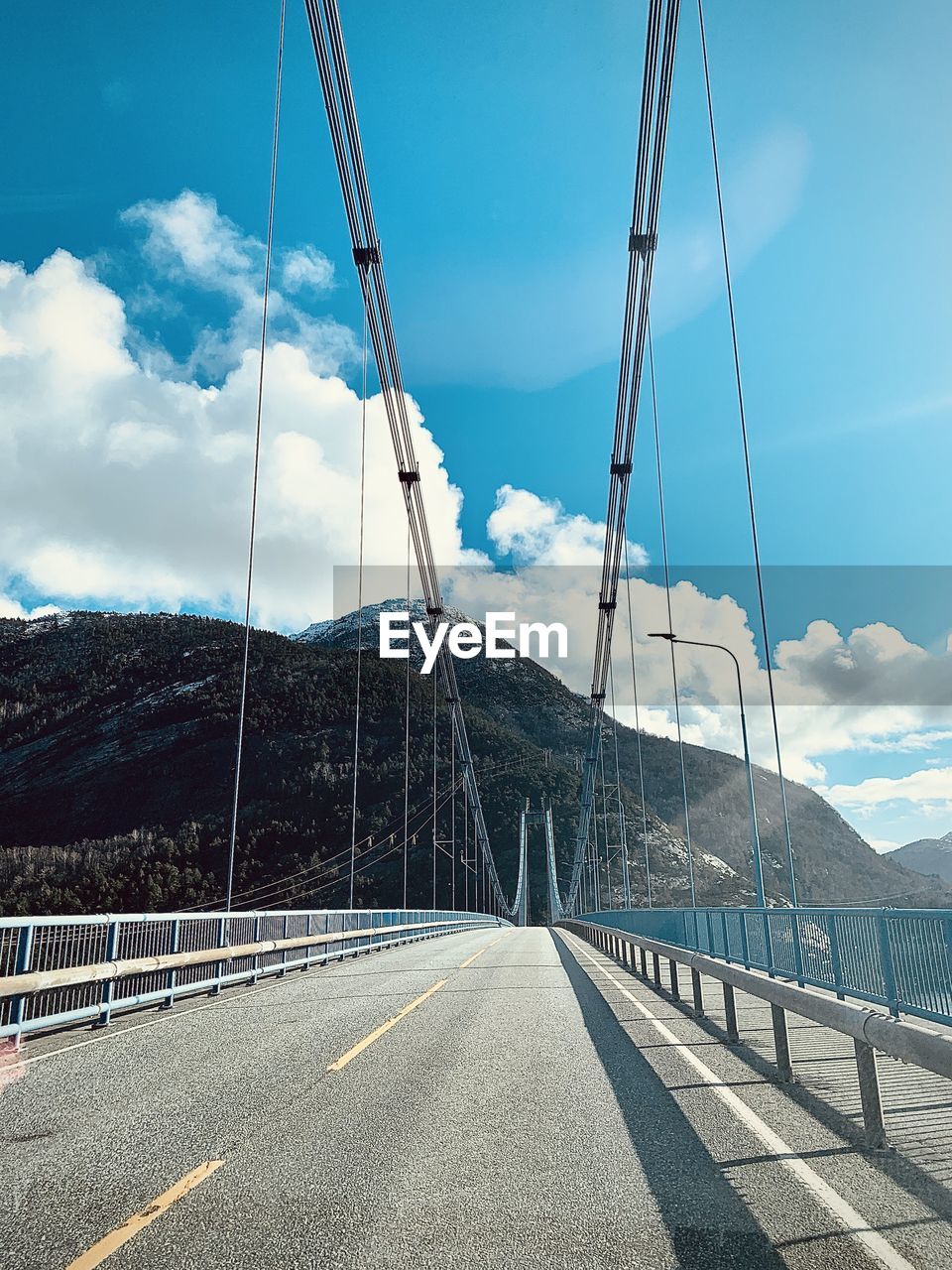 LOW ANGLE VIEW OF BRIDGE AGAINST MOUNTAIN