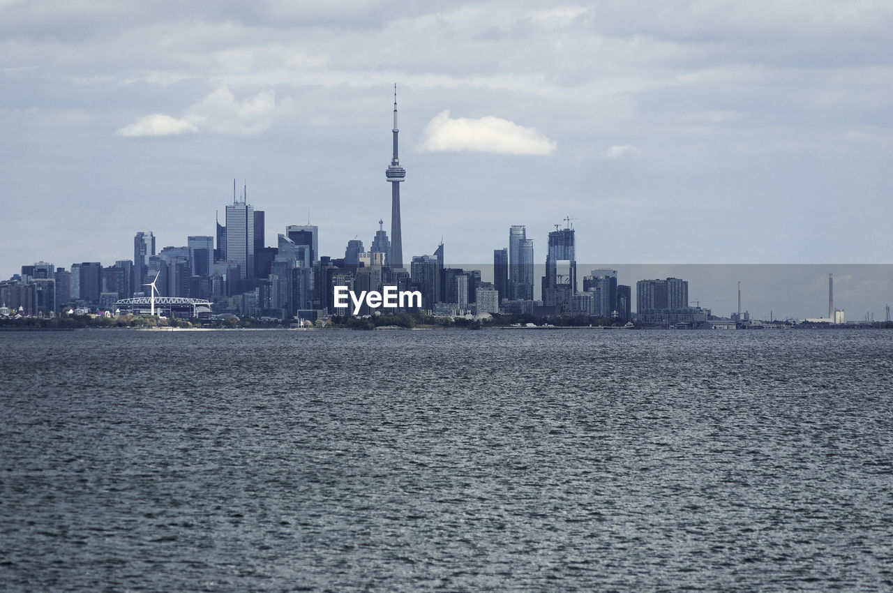 View of cityscape against cloudy sky