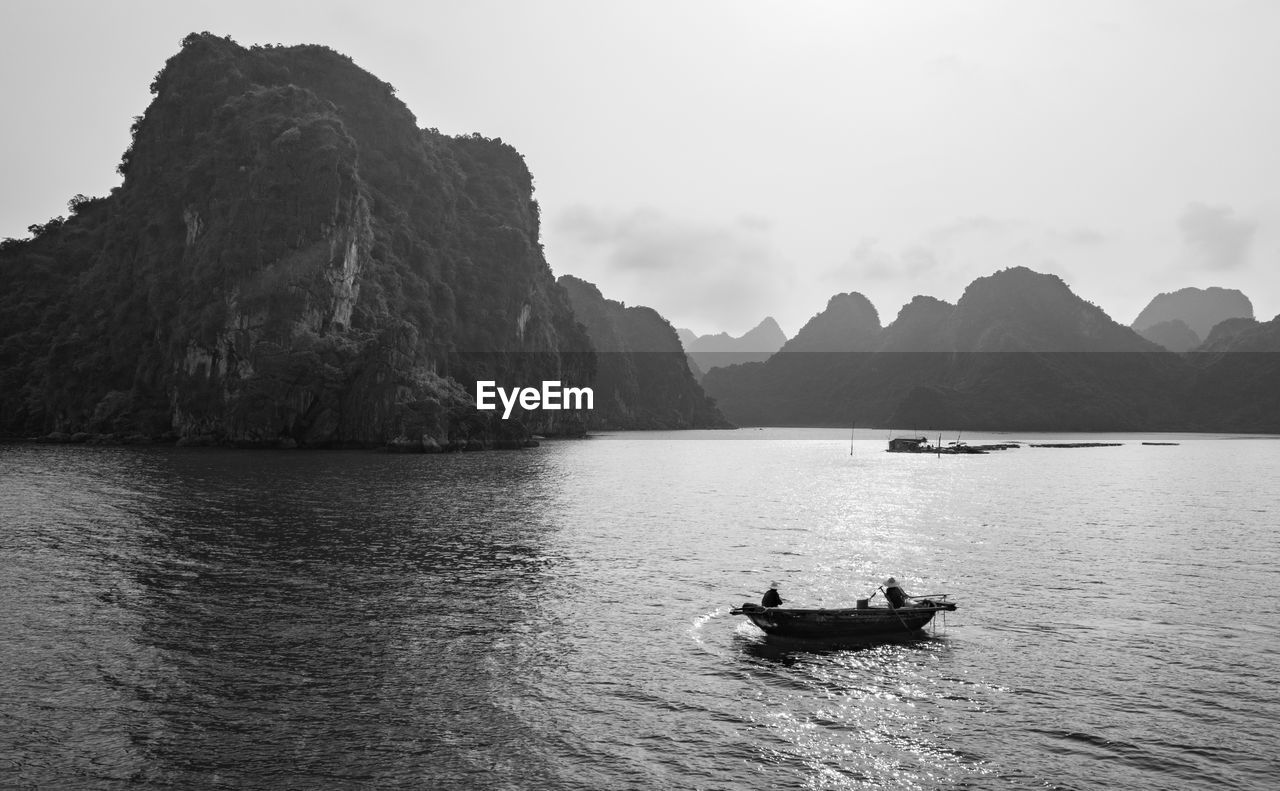 Scenic view of sea against mountain range