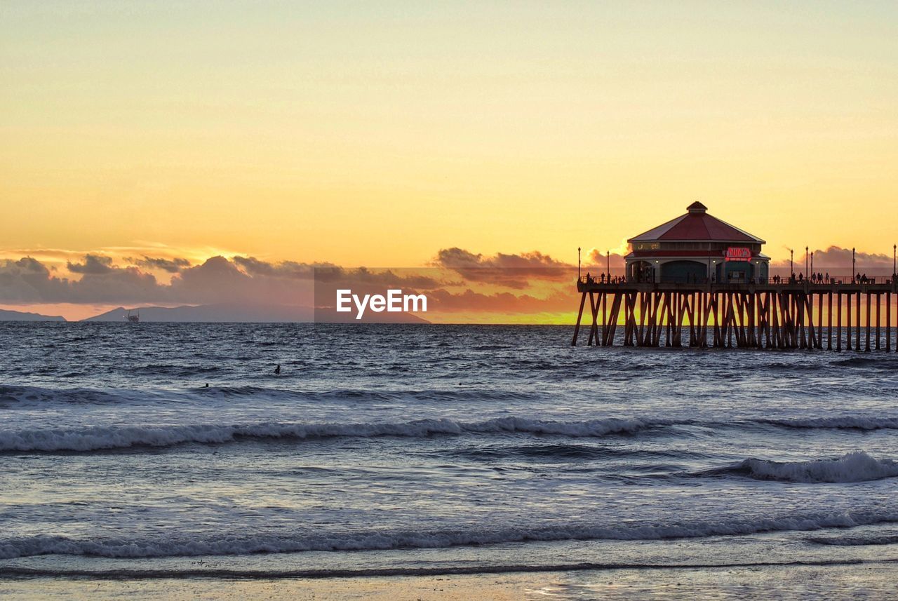 Scenic view of beach against sky during sunset