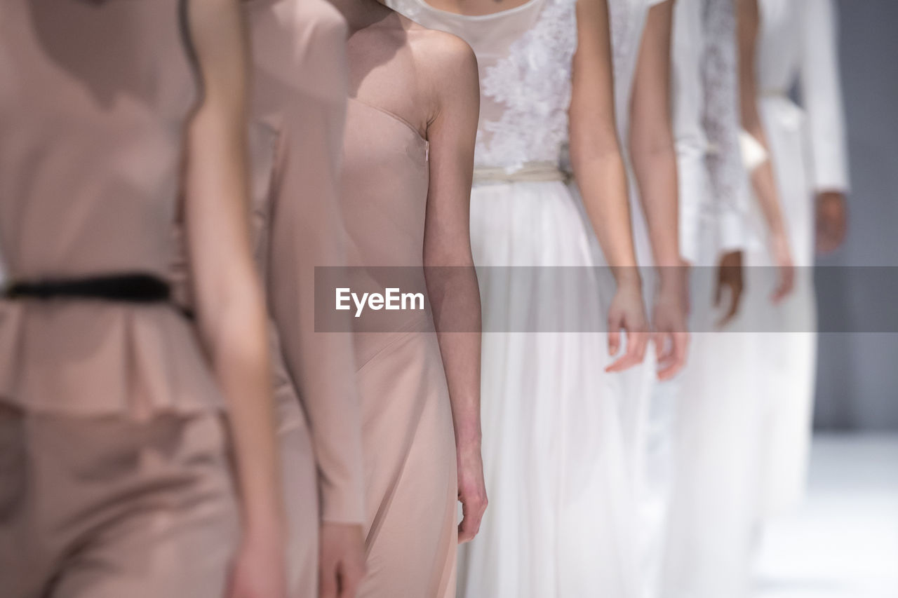 Low section of women standing on floor