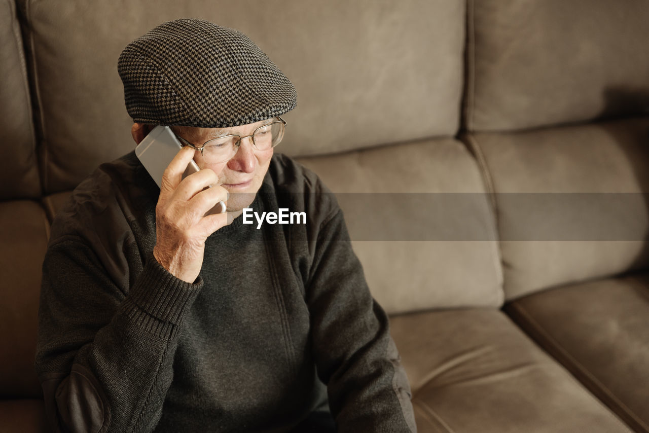 Senior man sitting on sofa