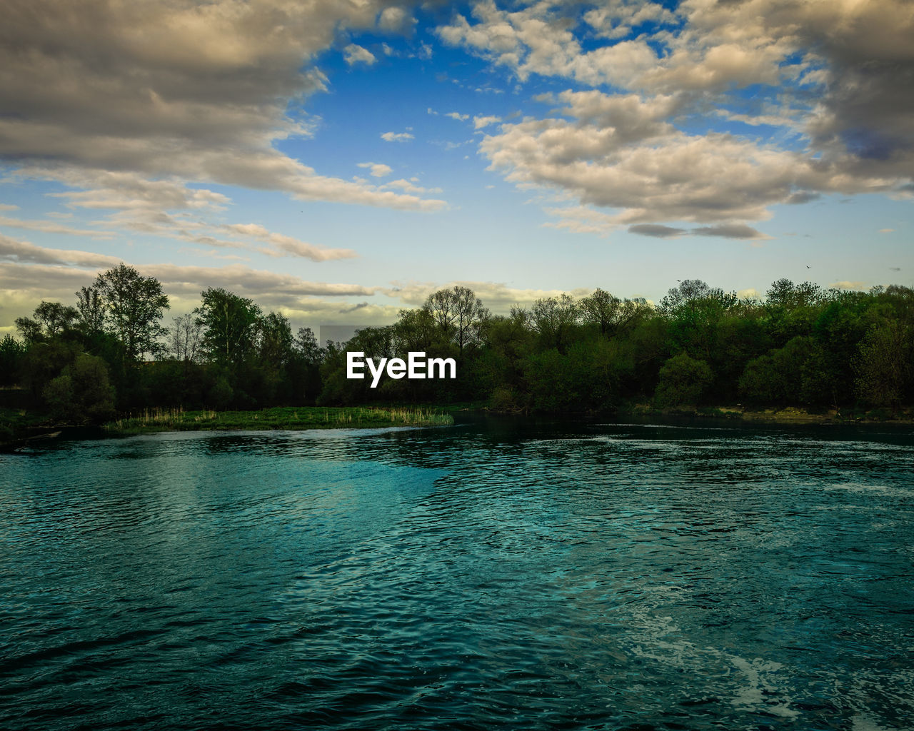 SCENIC VIEW OF LAKE BY TREES AGAINST SKY