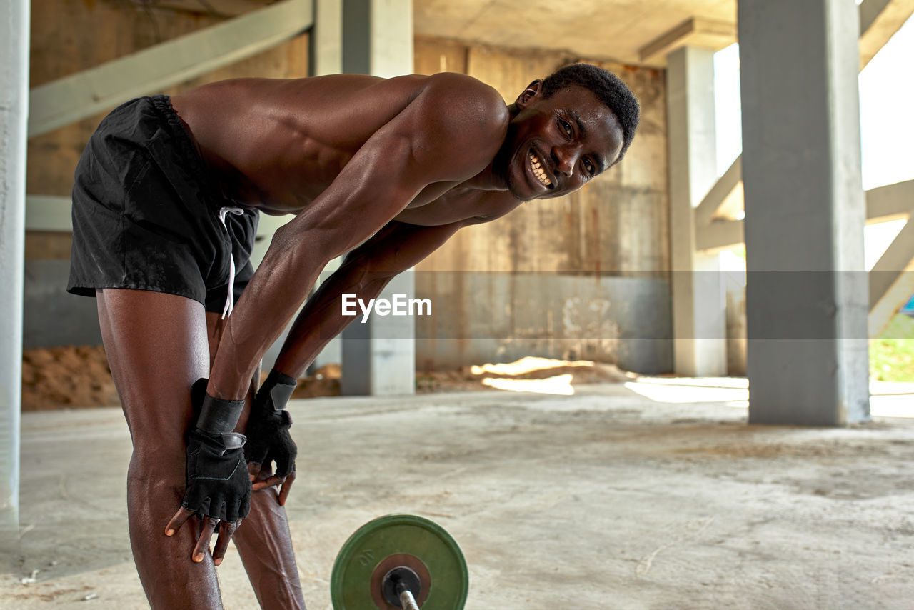 low section of man exercising on street