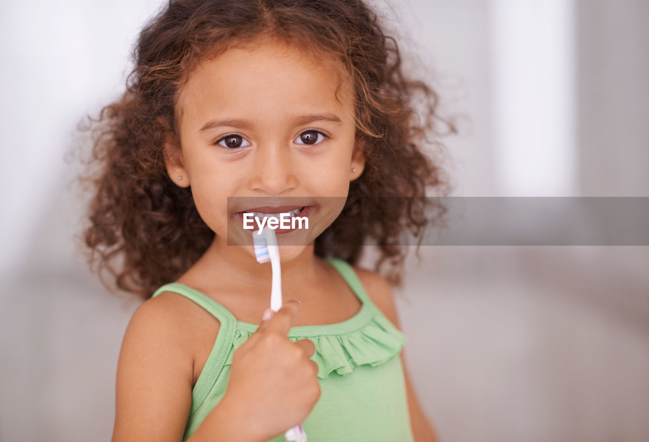 Close-up portrait of young woman drinking straw