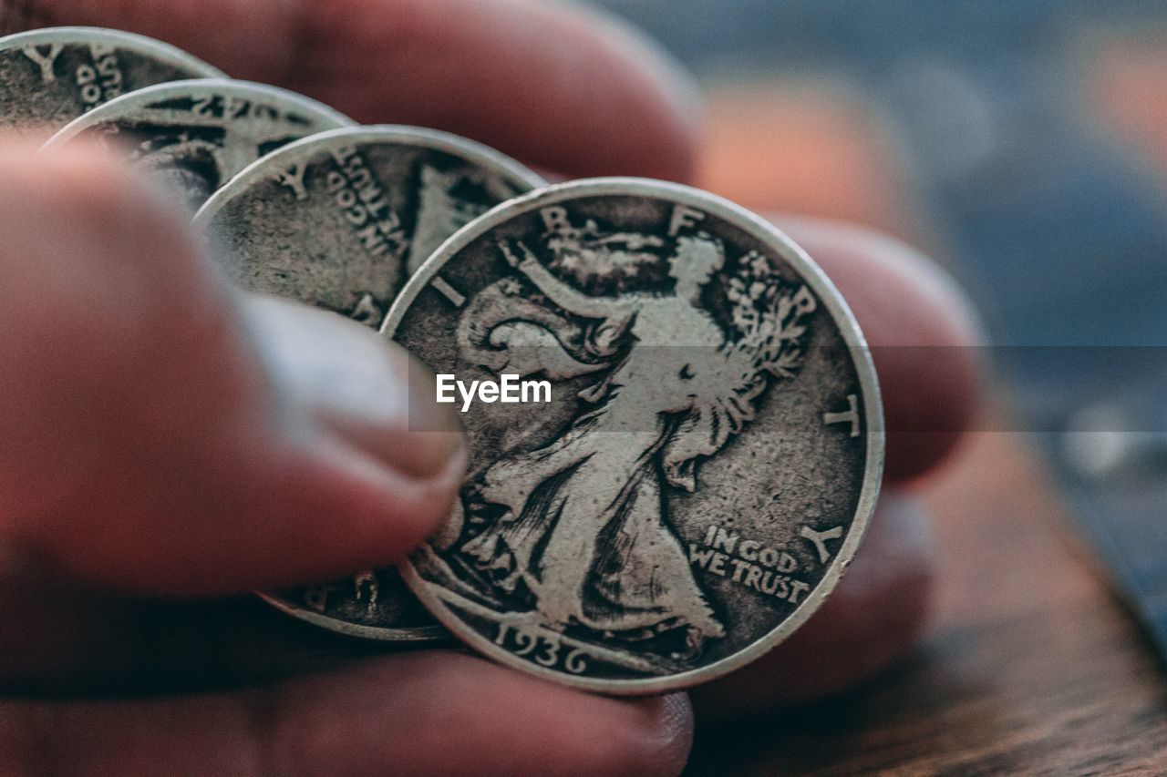 Cropped image of hand holding coins