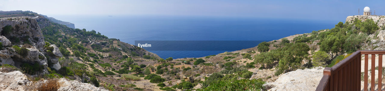 High angle view of sea and mountains against sky