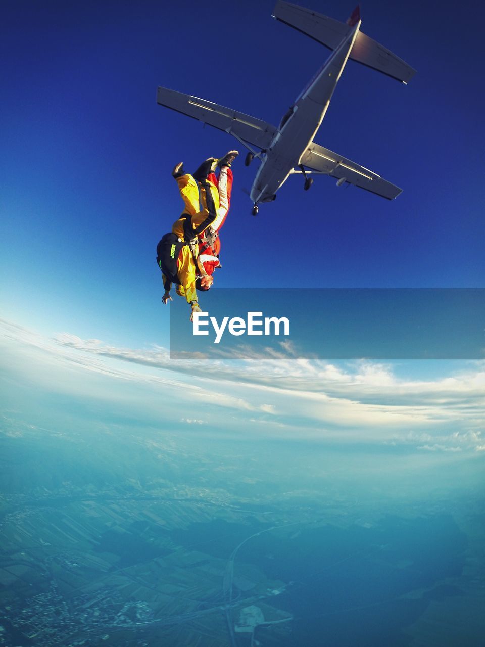 Low angle view of skydivers jumping from airplane