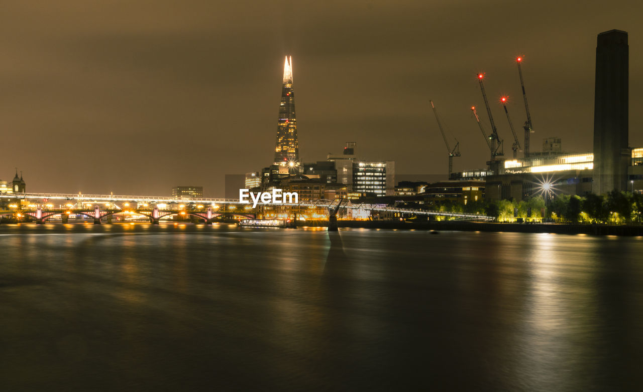 ILLUMINATED CITY BUILDINGS AT NIGHT