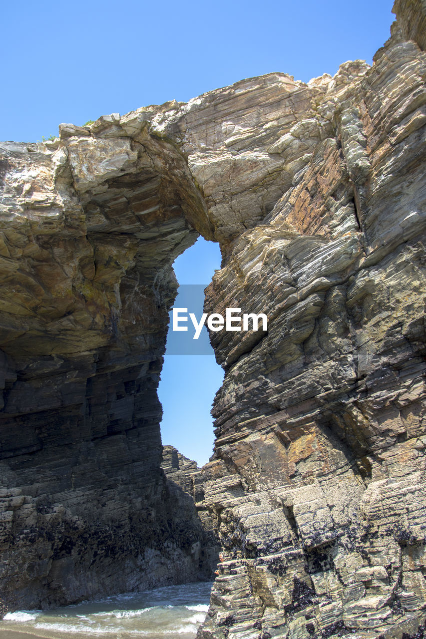 Low angle view of rock formations against sky