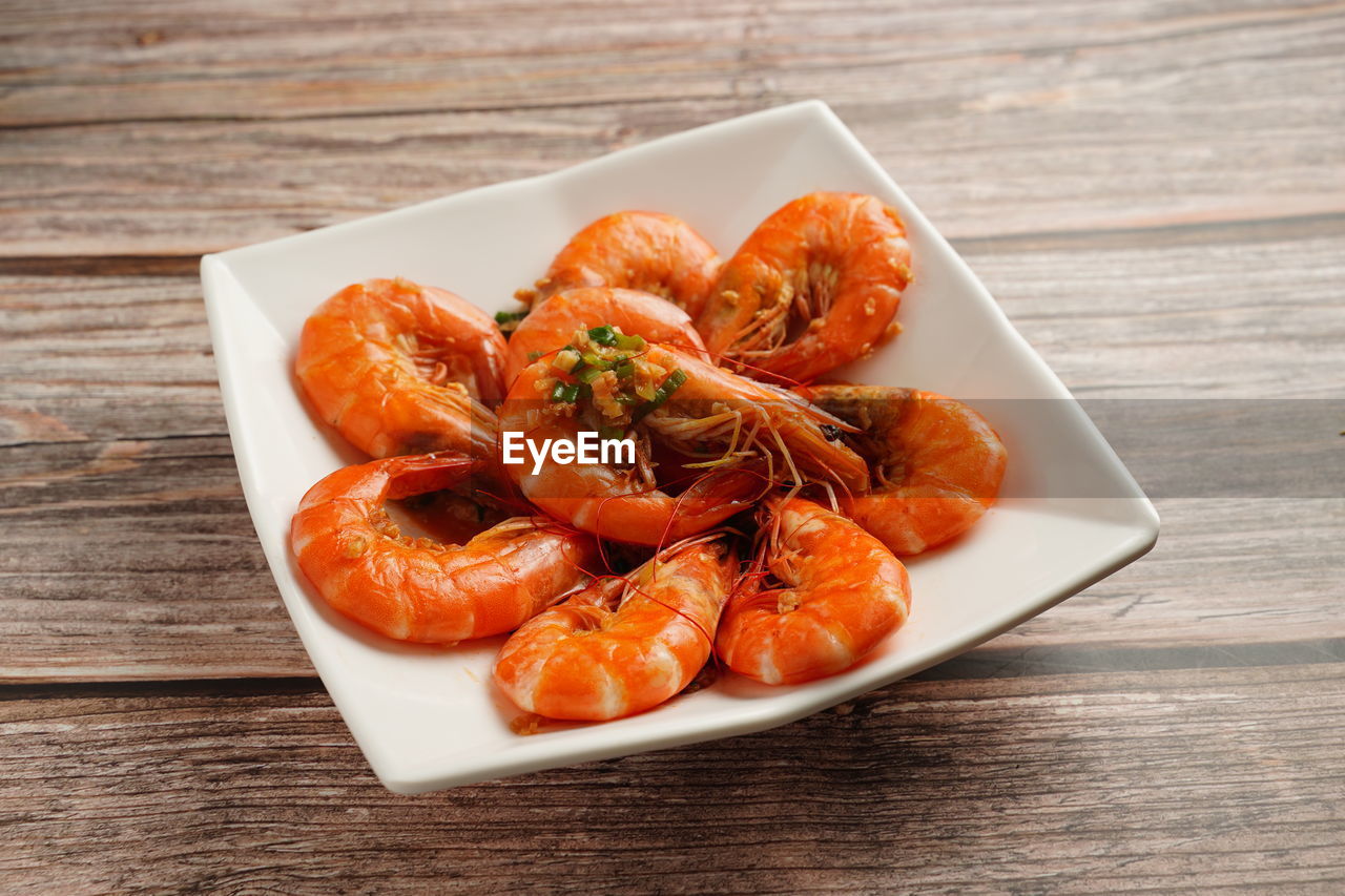 food and drink, food, freshness, healthy eating, wood, wellbeing, shrimp, table, dish, seafood, plate, no people, indoors, produce, close-up, studio shot, high angle view, fruit, cuisine, meal, crustacean, vegetable, still life, orange color, meat, scampi