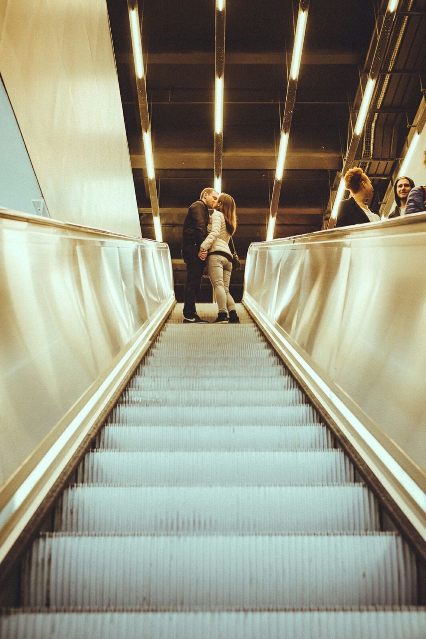 LOW ANGLE VIEW OF ILLUMINATED ESCALATORS