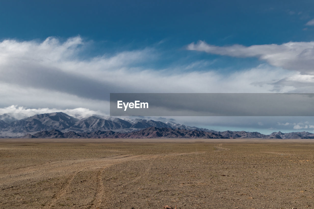 Scenic view of landscape and mountains against sky